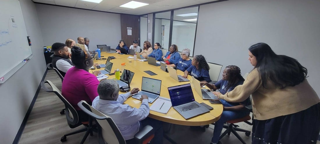 EHCEC staff learning together with laptops during Level Up Learning